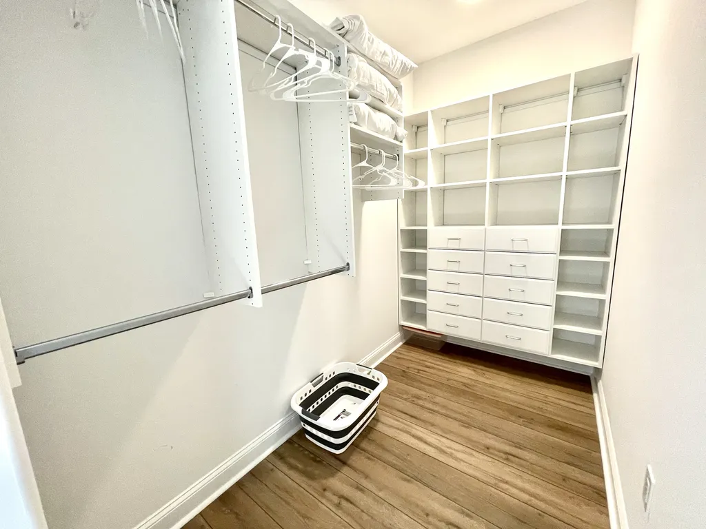 Primary bedroom walk in closet