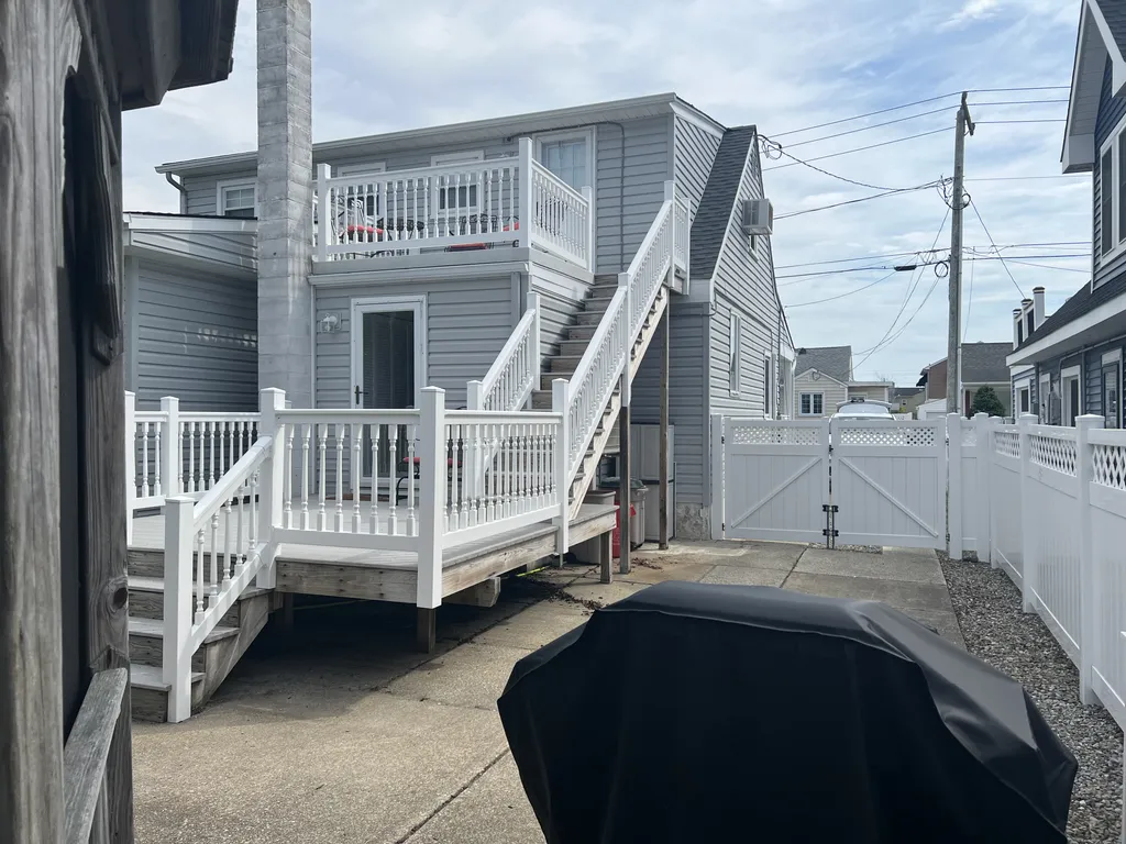 Back of the house has two decks and a second entrance for upstairs