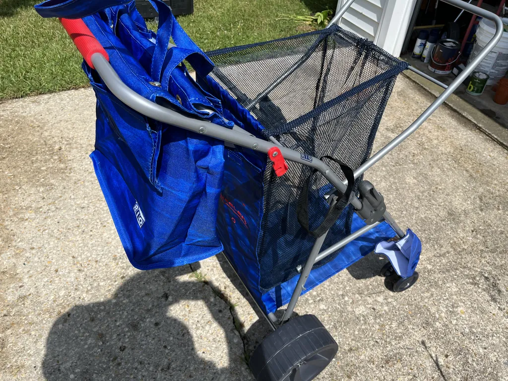 Beach caddy holds cooler, towels, snacks and at least 4 chairs.  Umbreallt also can be strapped to side