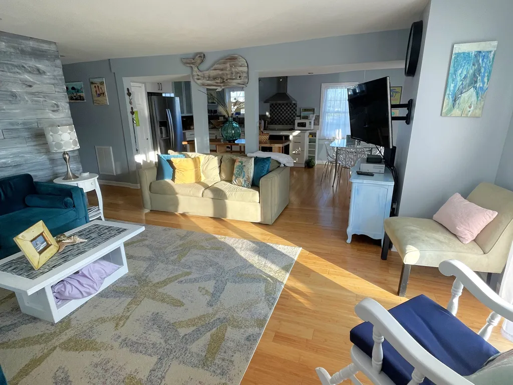 family room with 2 large couches, chair and rockerr