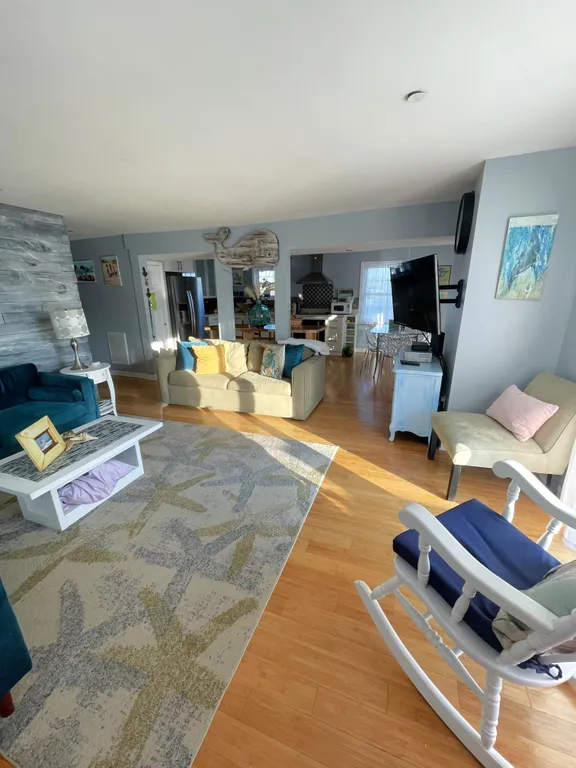 family room with 2 large couches, chair and rockerr