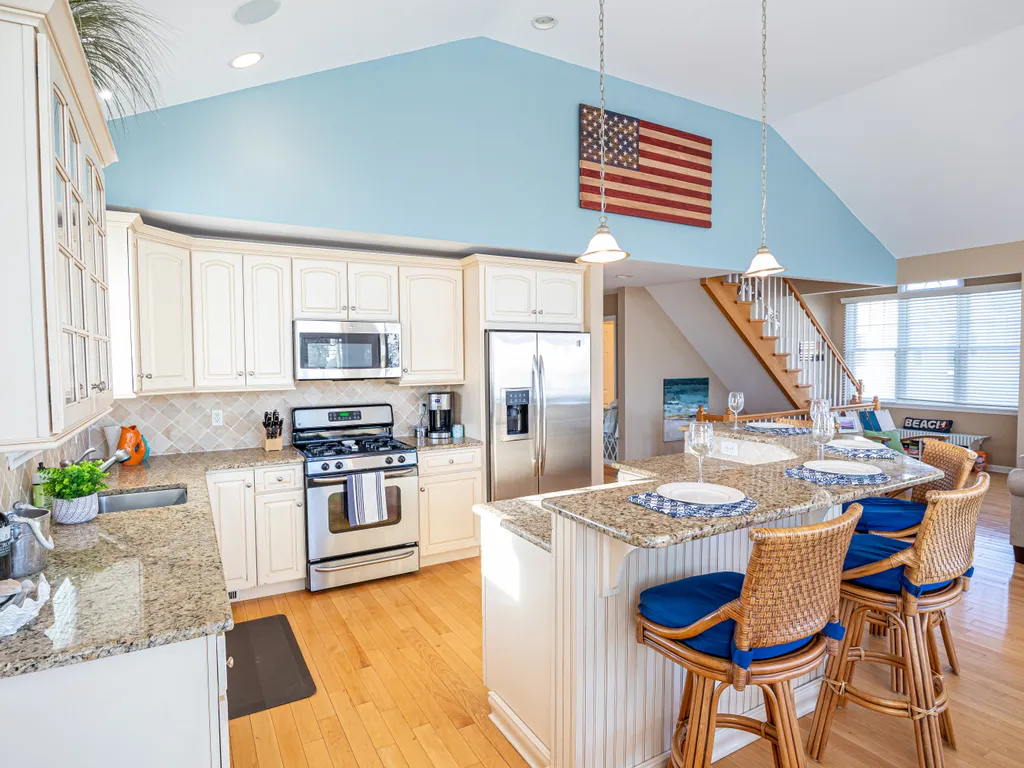 The beautiful kitchen features an oversized island with seating for four