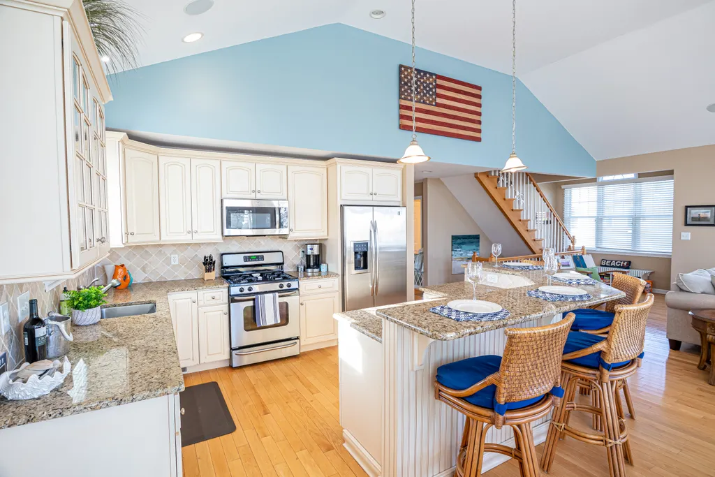 The beautiful kitchen features an oversized island with seating for four