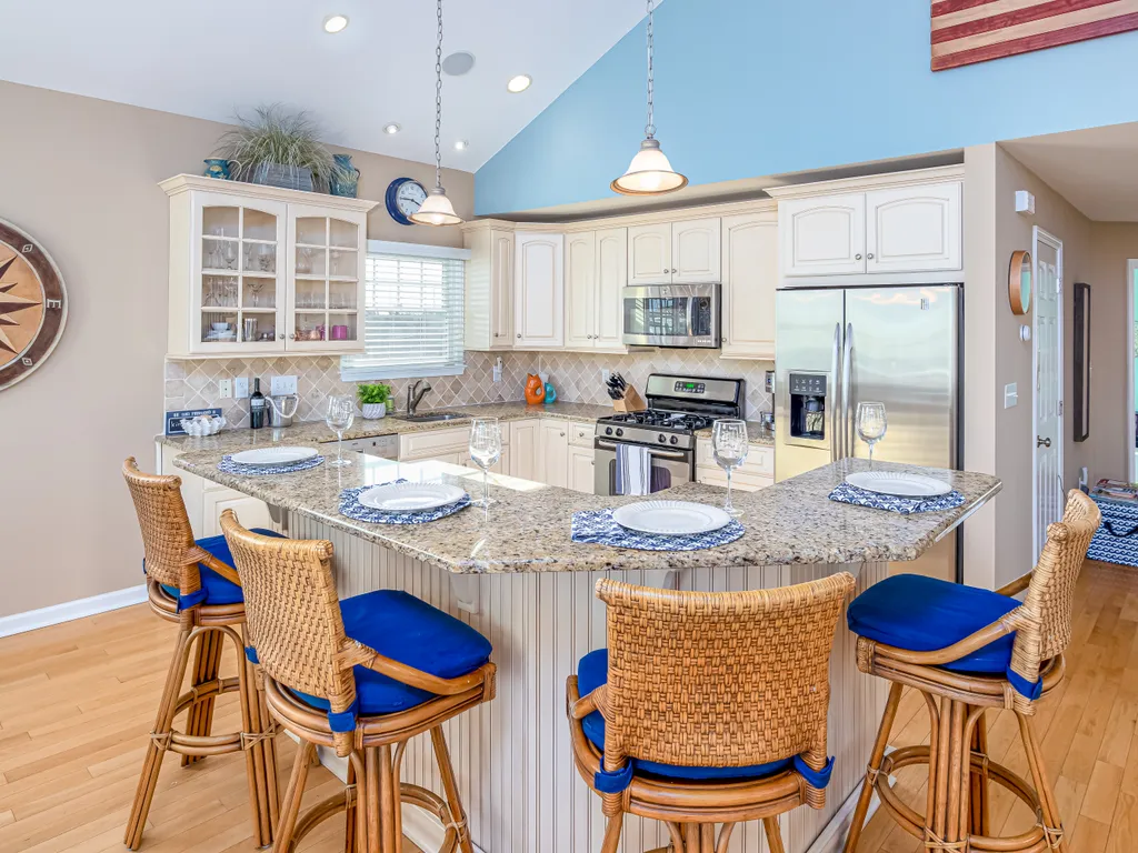 The beautiful kitchen features an oversized island with seating for four