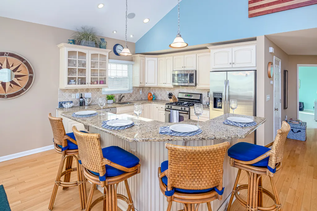 The beautiful kitchen features an oversized island with seating for four