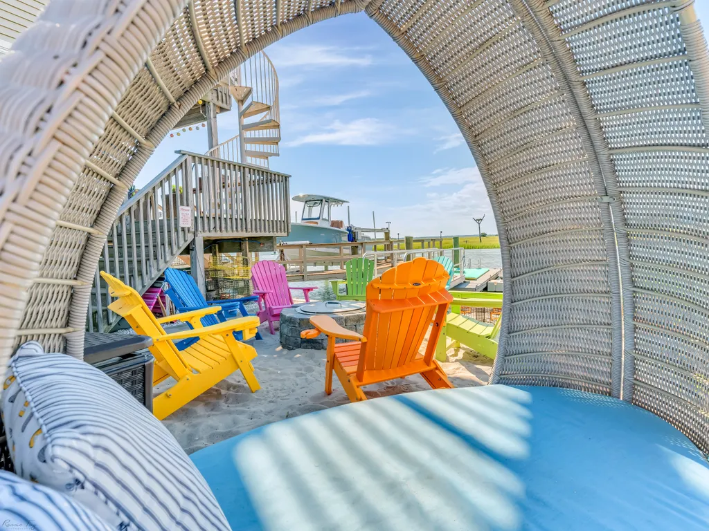Breveo fire pit surrounded by Adirondack chairs.