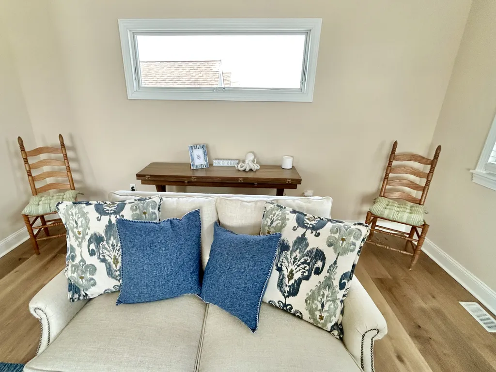 Table behind this love seat can be opened up easily and can be used to seat 4-6 more chairs.