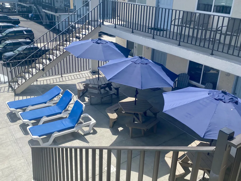 2nd floor sundeck with tables and Umbrellas