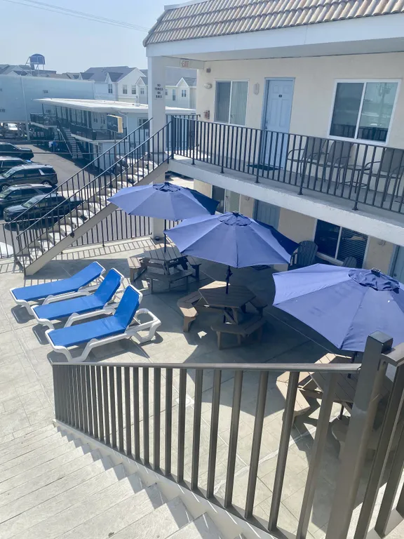 2nd floor sundeck with tables and Umbrellas