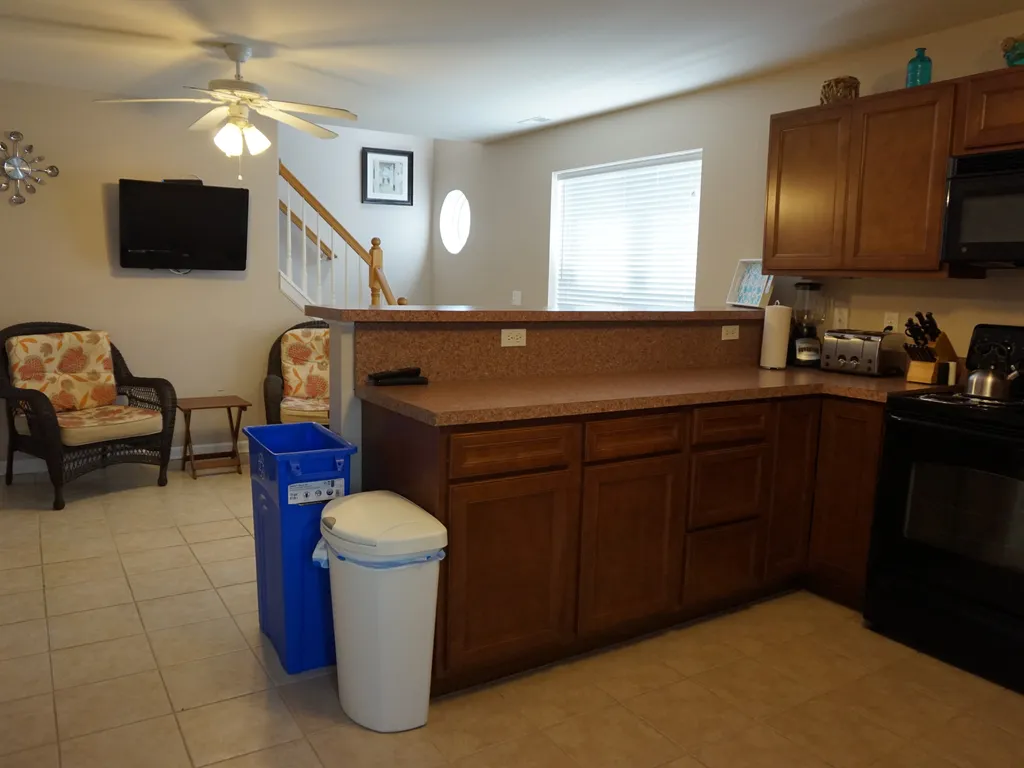 Kitchen to show TV and stairs to 2nd floor