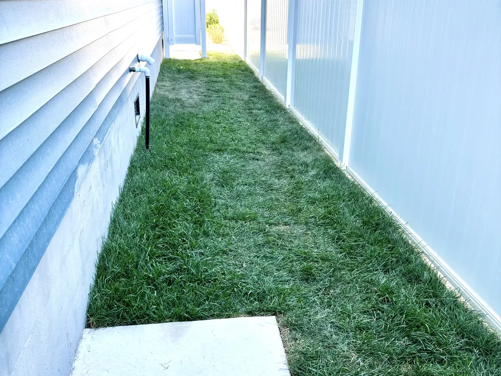 Side yard w full shower and turf for putting green, cornhole and bocce ball