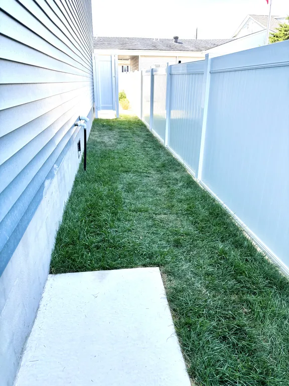 Side yard w full shower and turf for putting green, cornhole and bocce ball