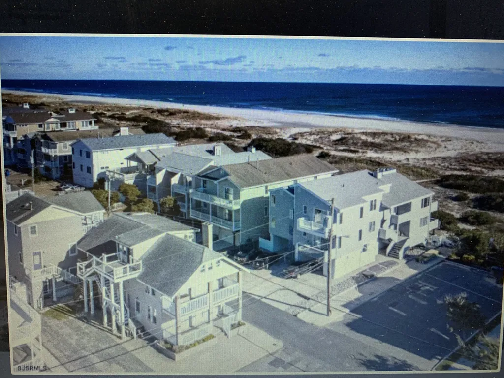 Just 1 house to the beach.  Drone photo of our home on the bottom left.
