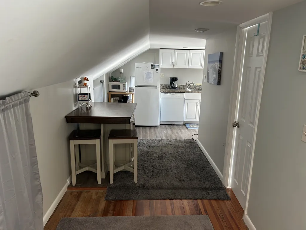 Hall with dining area and view of the kitchen.
