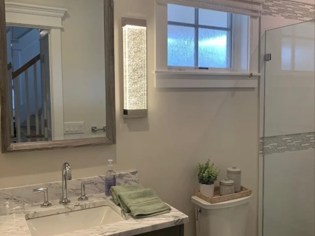 First floor powder room with shower across from Queen bedroome