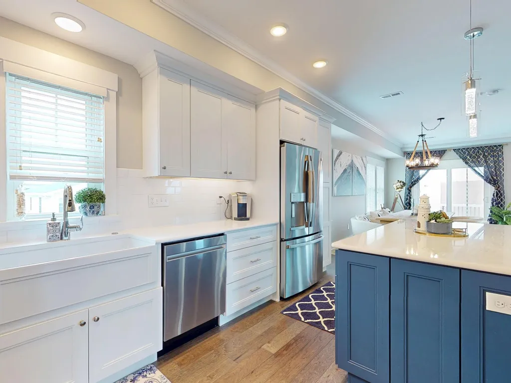 Gourmet kitchen with dishwasher, stove, fridge, bar fridge, oven