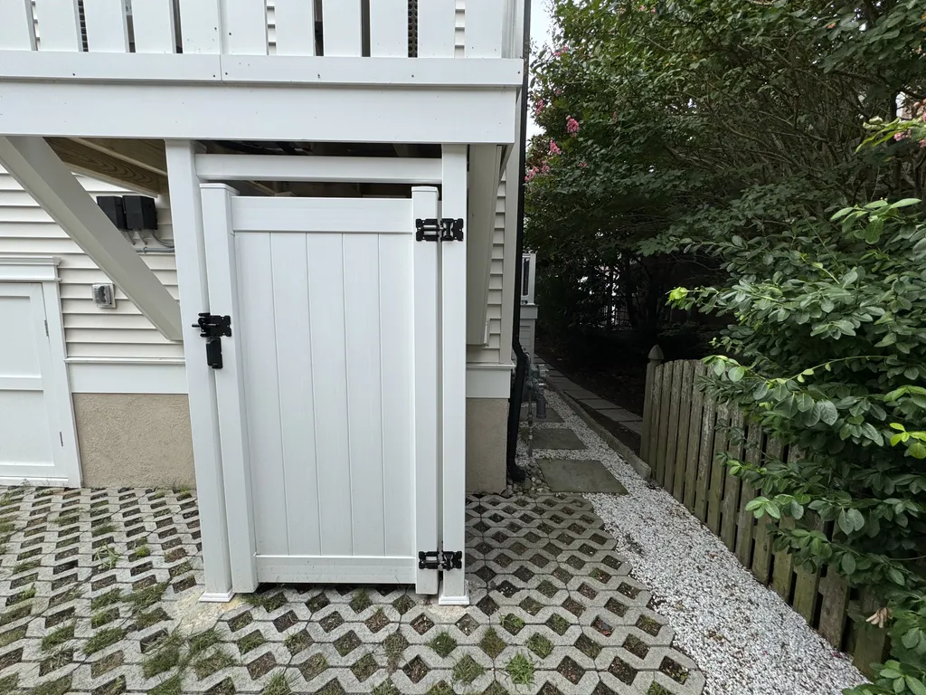 Private outdoor shower, stone paver path to elevator from garage level at back of house
