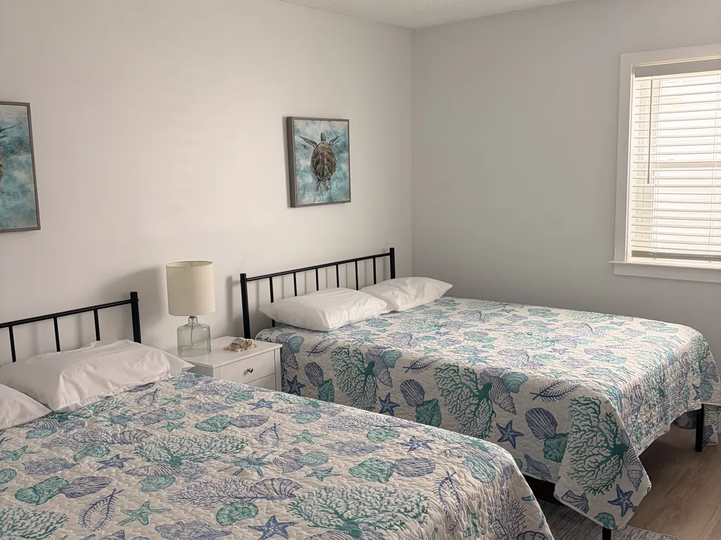 Bedroom two with two full beds.
