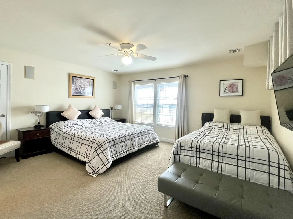 Master bedroom with one king, one full and one pull out twin bed.