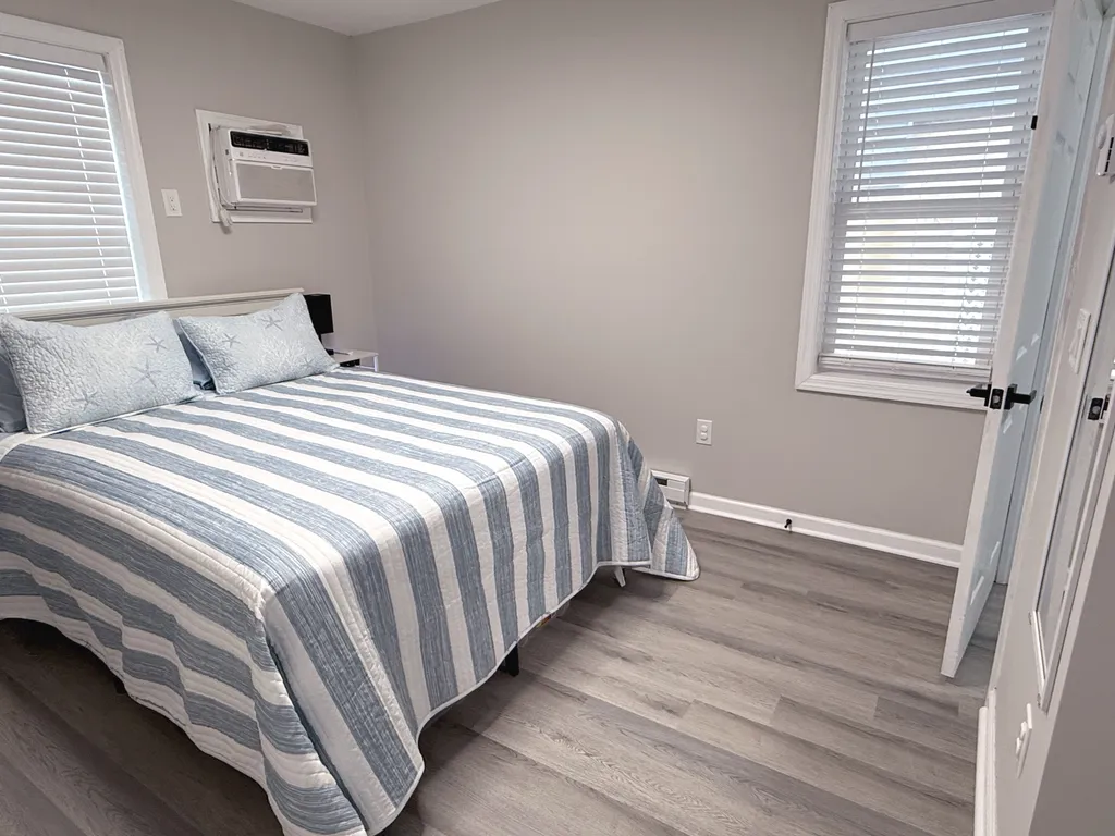 Second bedroom features queen bed and linens.