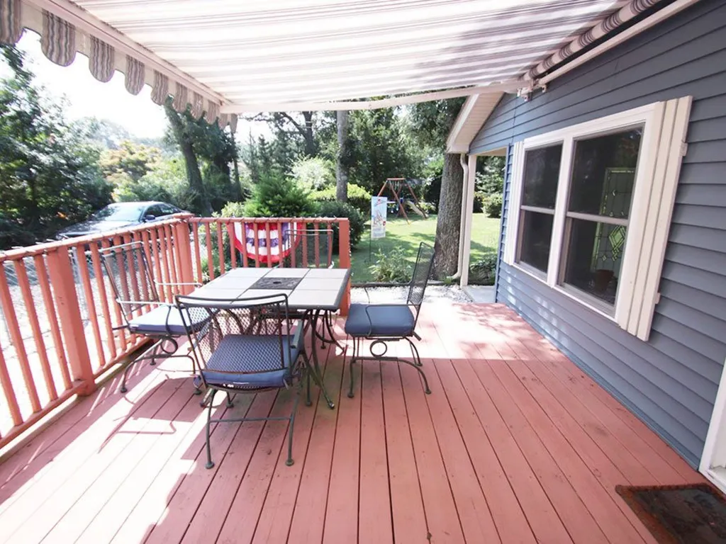 Awning covered deck with table &amp;amp; chairs