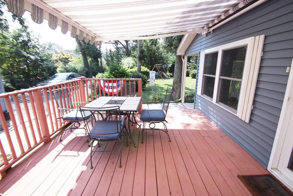 Awning covered deck with table &amp;amp; chairs