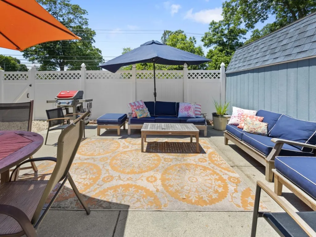 Poolside patio with sofa, loveseat and dining space