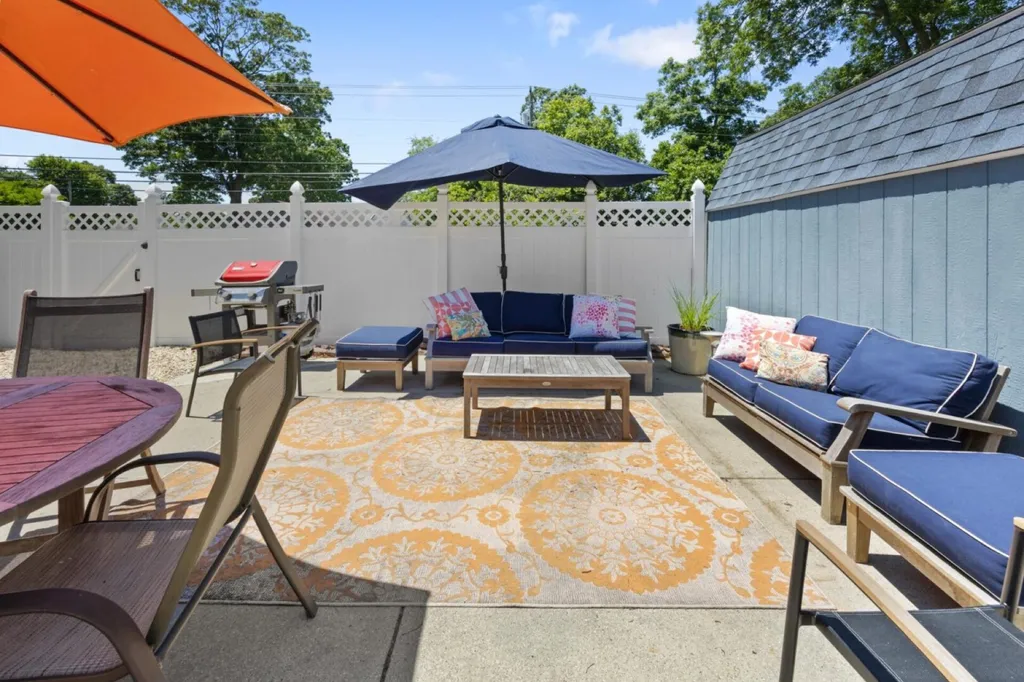 Poolside patio with sofa, loveseat and dining space