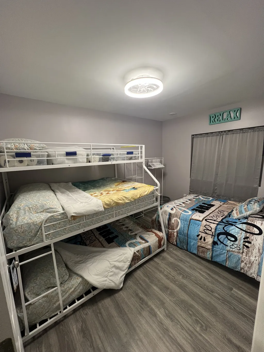One queen bed and one bunk bed with queen and full mattress
