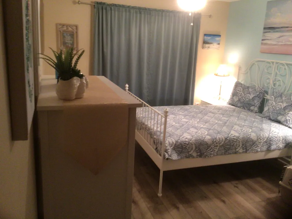 Master bedroom with dresser and closet.