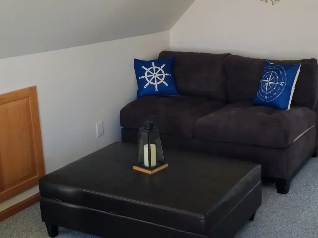 Love seat and ottoman that doubles as a storage space.