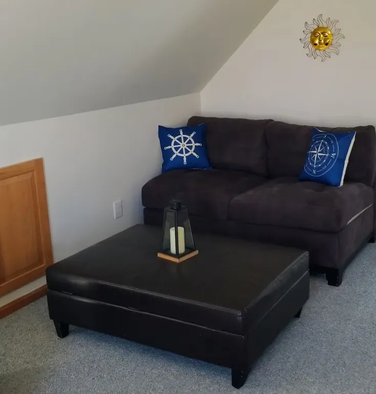 Love seat and ottoman that doubles as a storage space.