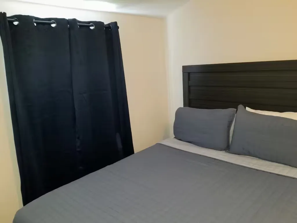 Queen size bedroom with room darken drapes.