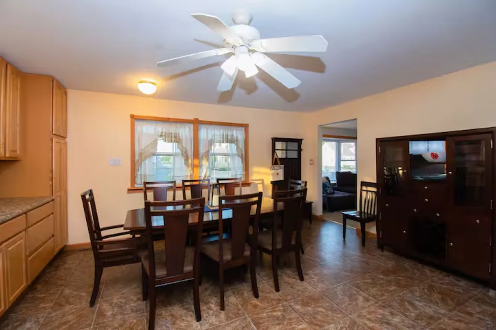 The dining area features a sturdy and stylish table, large enough to comfortably accommodate your group