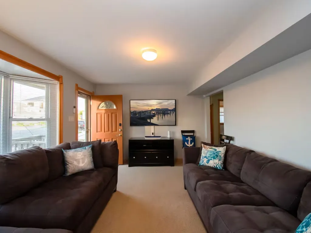 This beach house living room is a tranquil oasis adorned with coastal-inspired decor and a relaxed, laid-back ambiance.