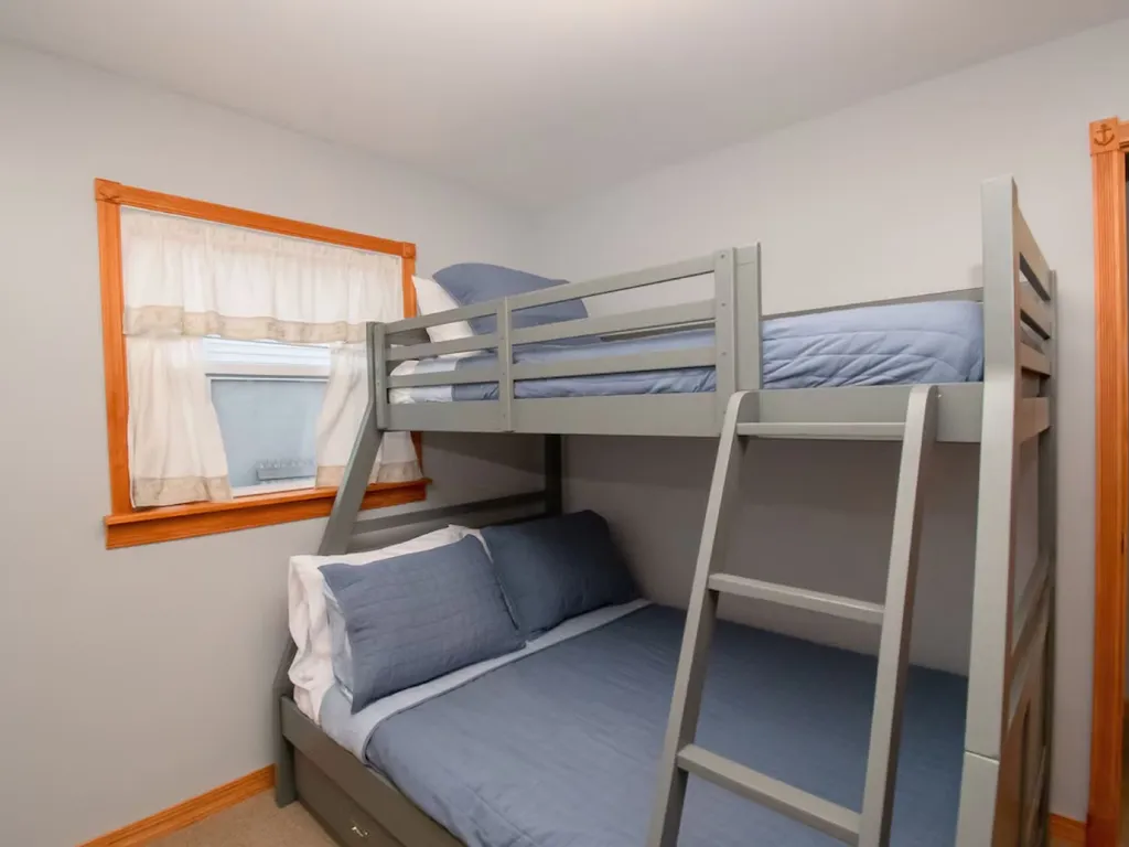 The beach-themed bunk bed room captures the essence of coastal living, with vibrant colors, nautical accents, and comfortable sleeping arrangements that make it a delightful space for beach-loving adventurers.