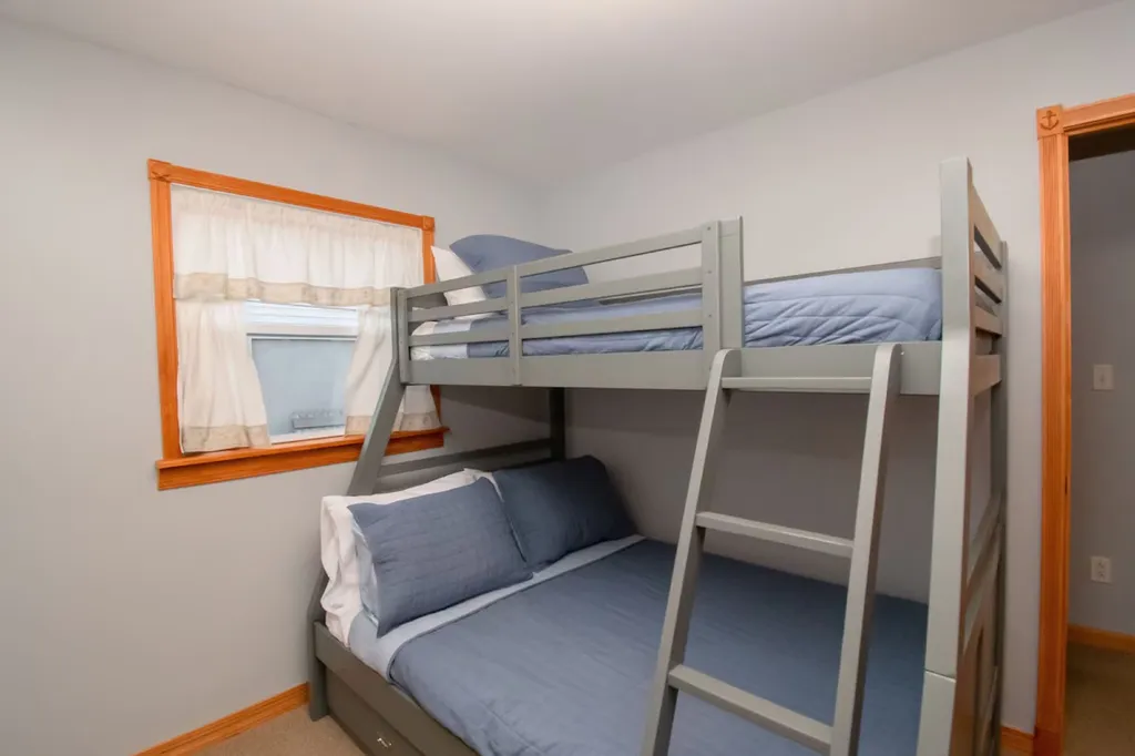 The beach-themed bunk bed room captures the essence of coastal living, with vibrant colors, nautical accents, and comfortable sleeping arrangements that make it a delightful space for beach-loving adventurers.