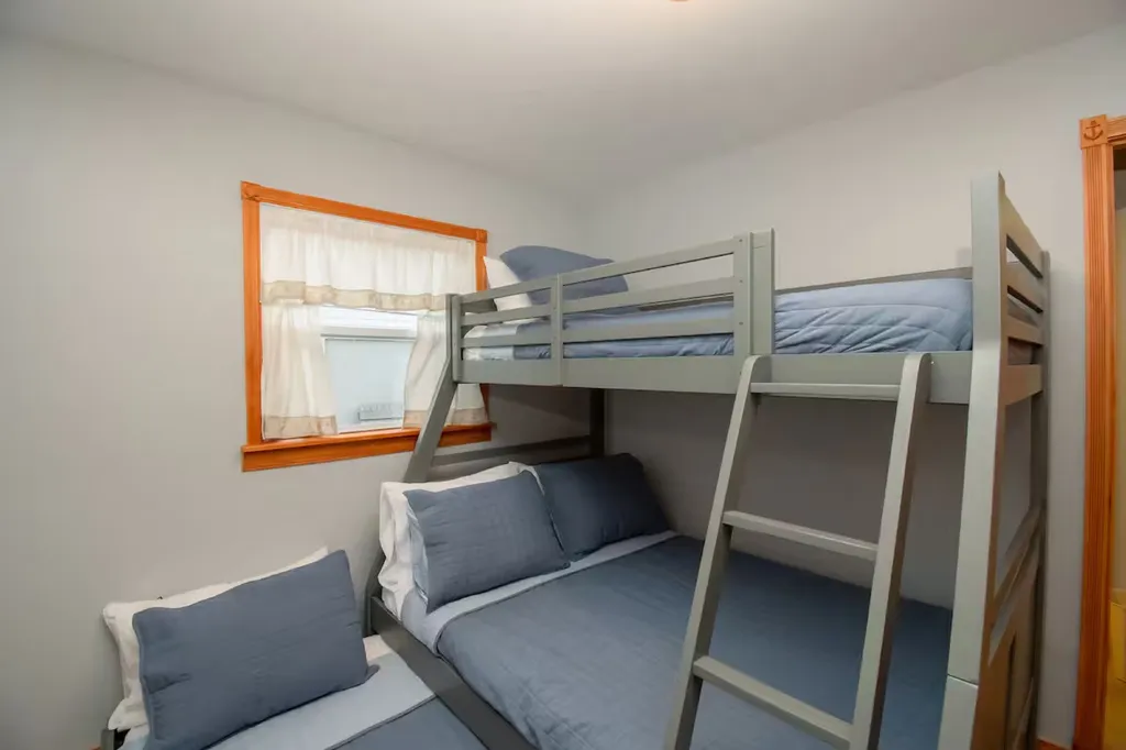 The bunk bed room provides a playful and efficient sleeping arrangement for up to four people, featuring sturdy and stylish bunk beds that maximize space without compromising on comfort.