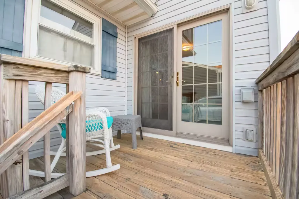 This outdoor deck area is a relaxing retreat with comfortable seating, and a serene ambiance, perfect for enjoying the fresh air and picturesque views. It is one of three decks.