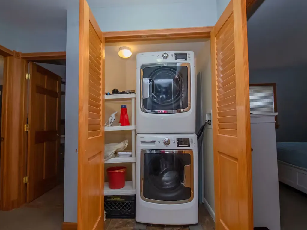 The laundry closet is a compact and efficient space equipped with a washer, dryer