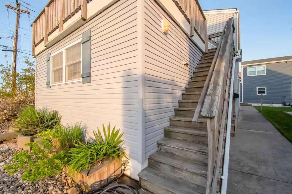 The stairs to second floor is located in front of the second driveway for two cars