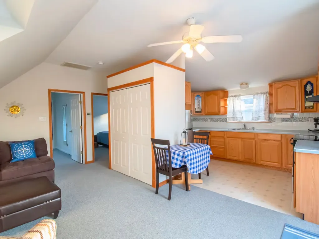 Second-floor kitchen with collapsible table seating four-fully equipped