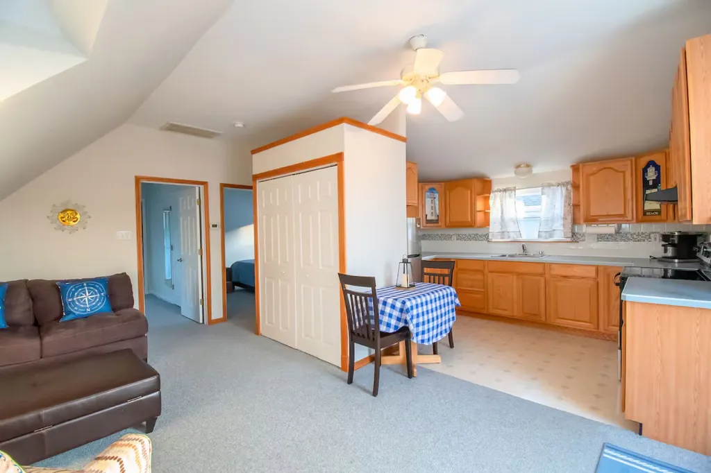 Second-floor kitchen with collapsible table seating four-fully equipped
