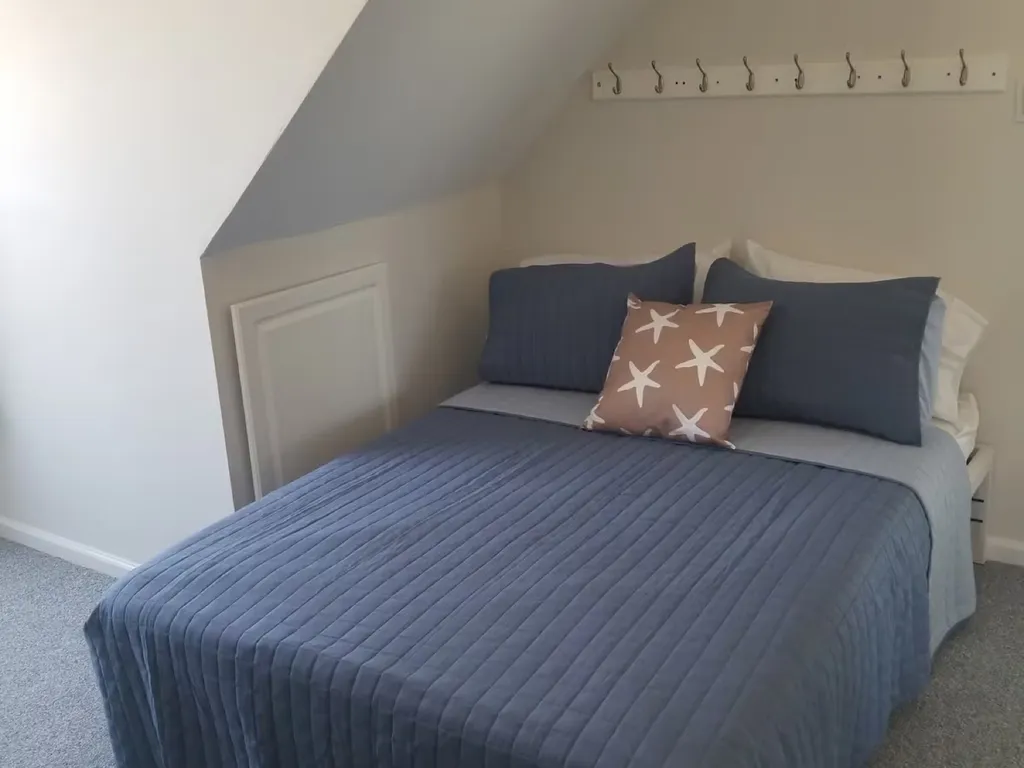 Full-size bed with small deck and Flat screen TV and black out curtains