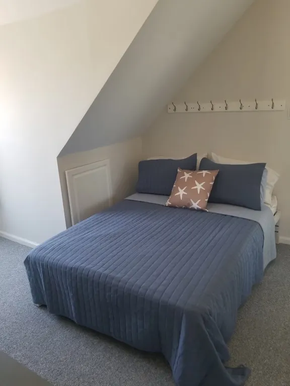Full-size bed with small deck and Flat screen TV and black out curtains