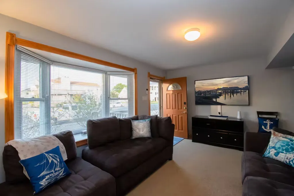 Plenty of seating in the living room with 64 inch Flat Screen TV- UTube TV and Wi-Fi available for streaming your favorite apps