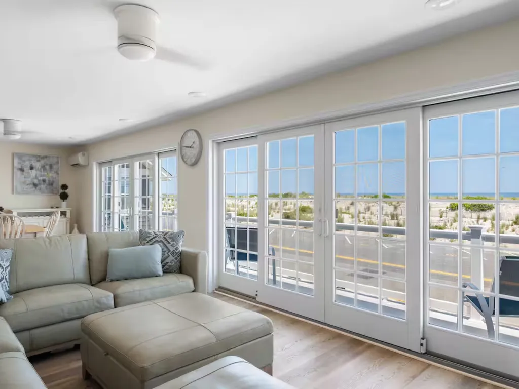 Main floor living area open to full kitchen and dining table Slider opens to front deck
