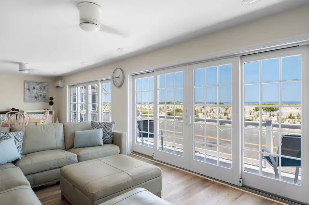 Main floor living area open to full kitchen and dining table Slider opens to front deck