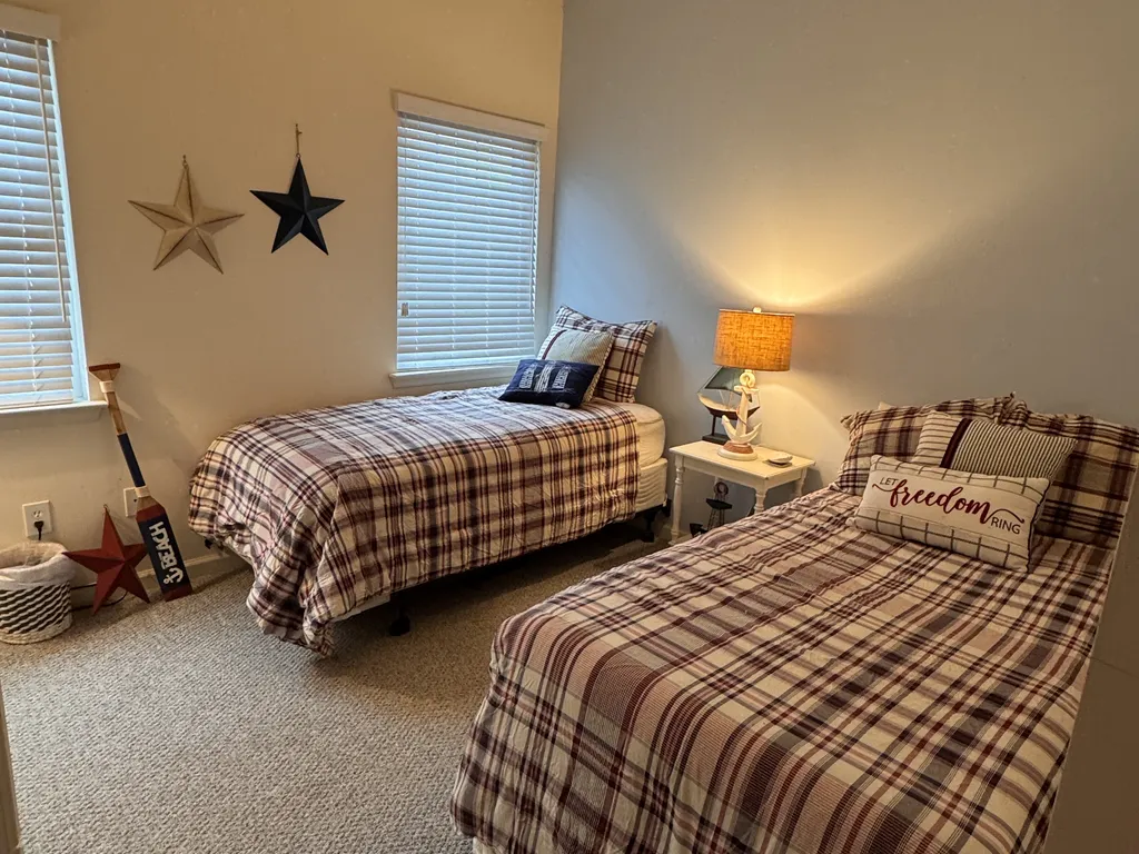 Bedroom #4 is on the main level with two twin beds, power tower on the nightstand and 43&amp;quot; smart TV