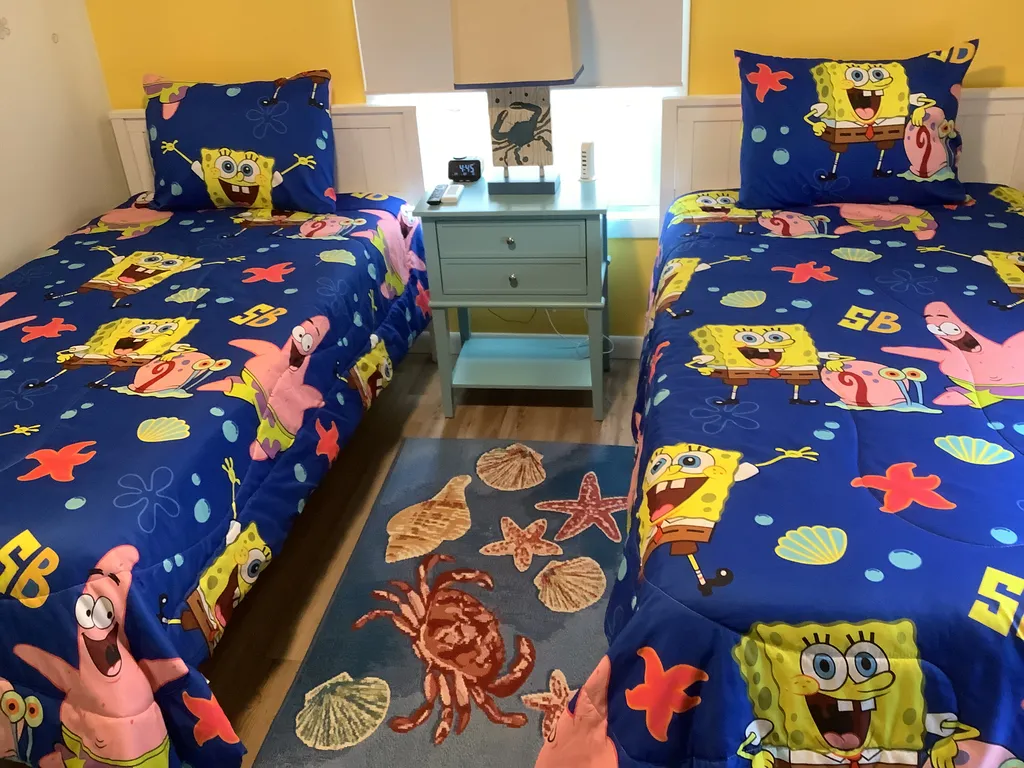A fun SpongeBob-themed bedroom featuring two comfortable twin beds.